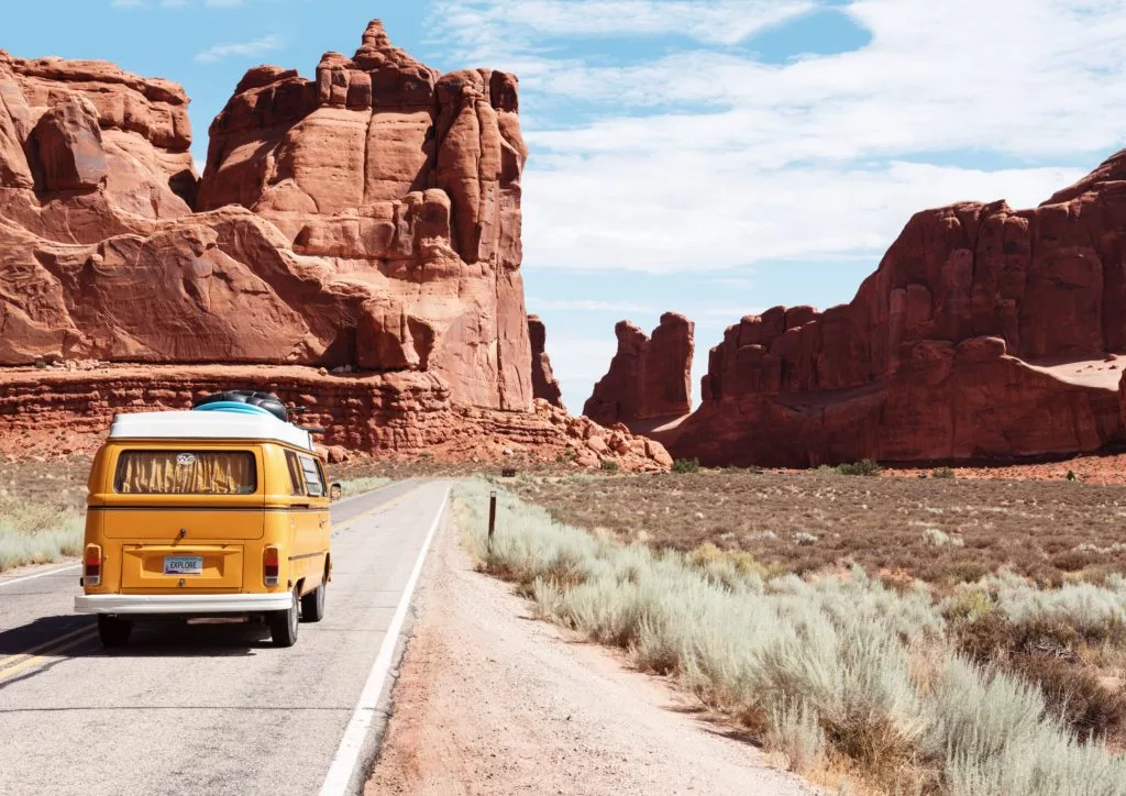 yellow van on a road at a national park